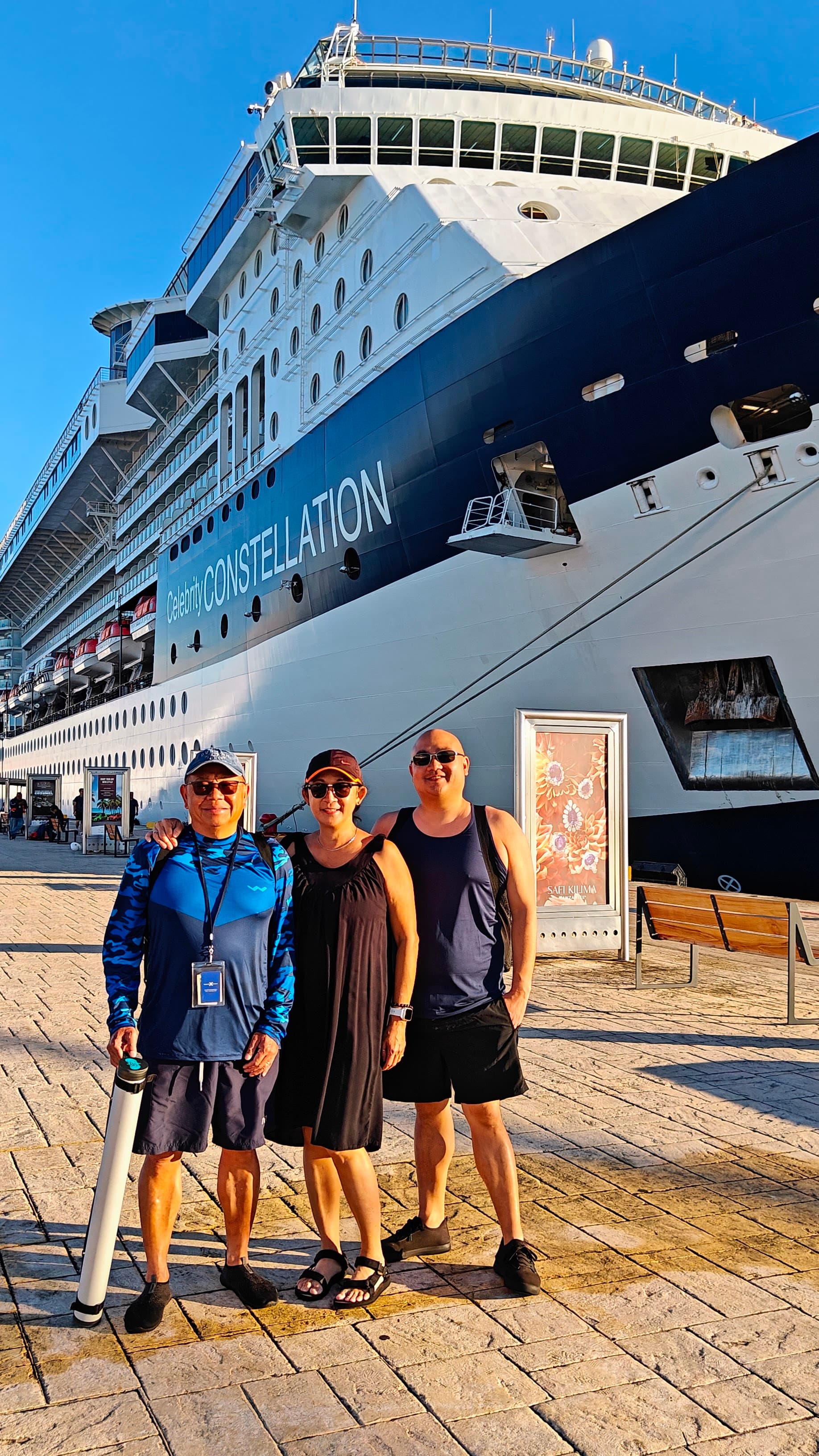 Family photo on a cruise ship in port.