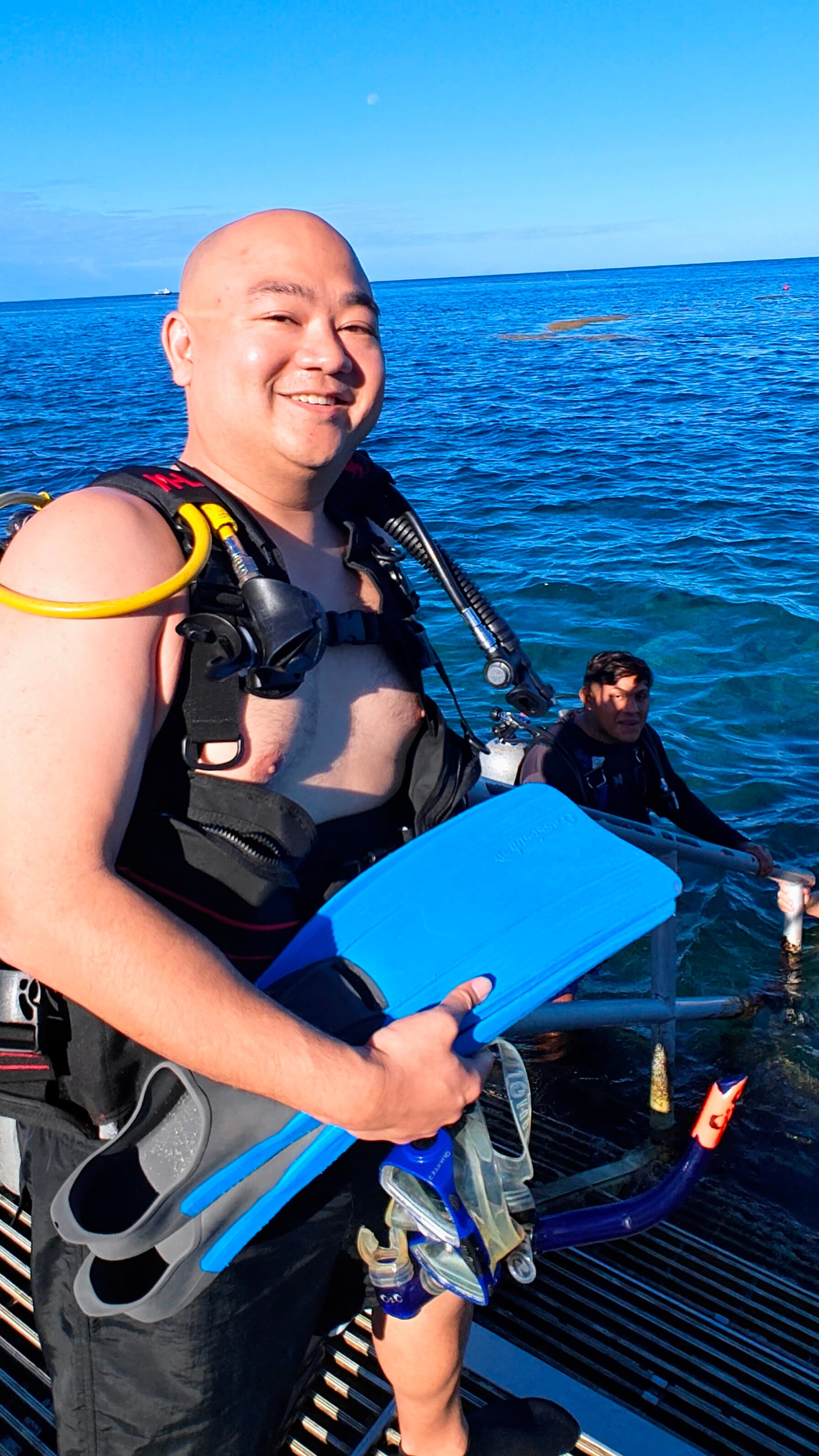 Kris geared up with fins, about to enter the water.